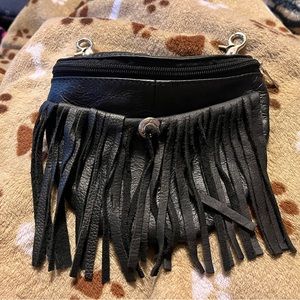 Black leather belt-loop pouch with half-moon zipper. Concho Fringe detail front